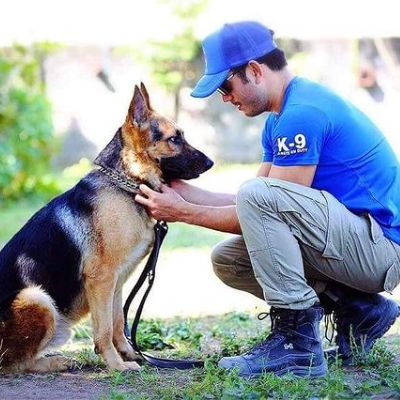 Photo of Sam Milby holding the german shepherd.